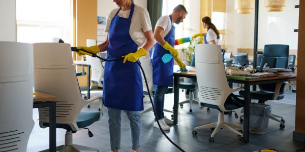 professional-cleaning-service-person-using-vacuum-cleaner-office